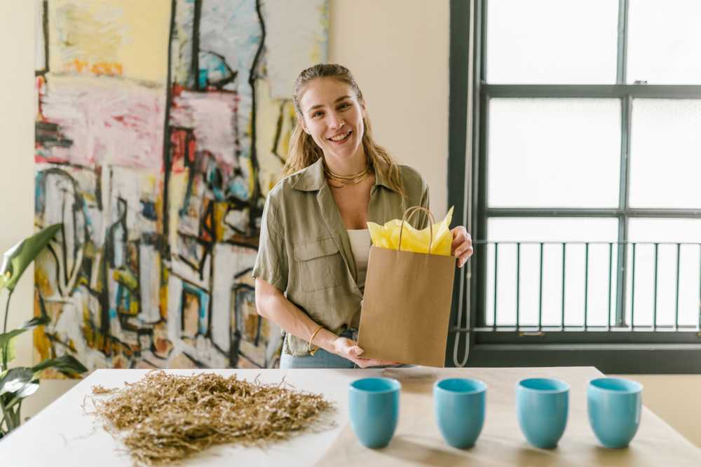 Business woman packaging mugs